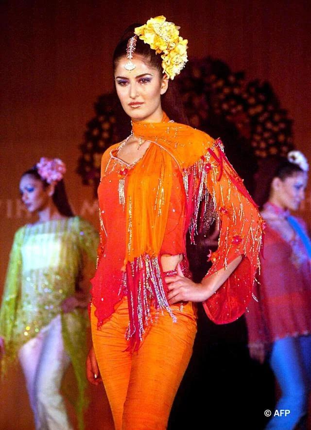Setting the fashion world ablaze, Katrina Kaif makes a bold statement in vibrant orange jeans and an eye-catching orange-red top. Adding a touch of elegance, she drapes a beautiful dupatta around her neck. And to top it all off, a stunning flower arrangement adorns her head, accentuating her beauty and grace Setting the fashion world ablaze, Katrina Kaif makes a bold statement in vibrant orange jeans and an eye-catching orange-red top. Adding a touch of elegance, she drapes a beautiful dupatta around her neck. And to top it all off, a stunning flower arrangement adorns her head, accentuating her beauty and grace